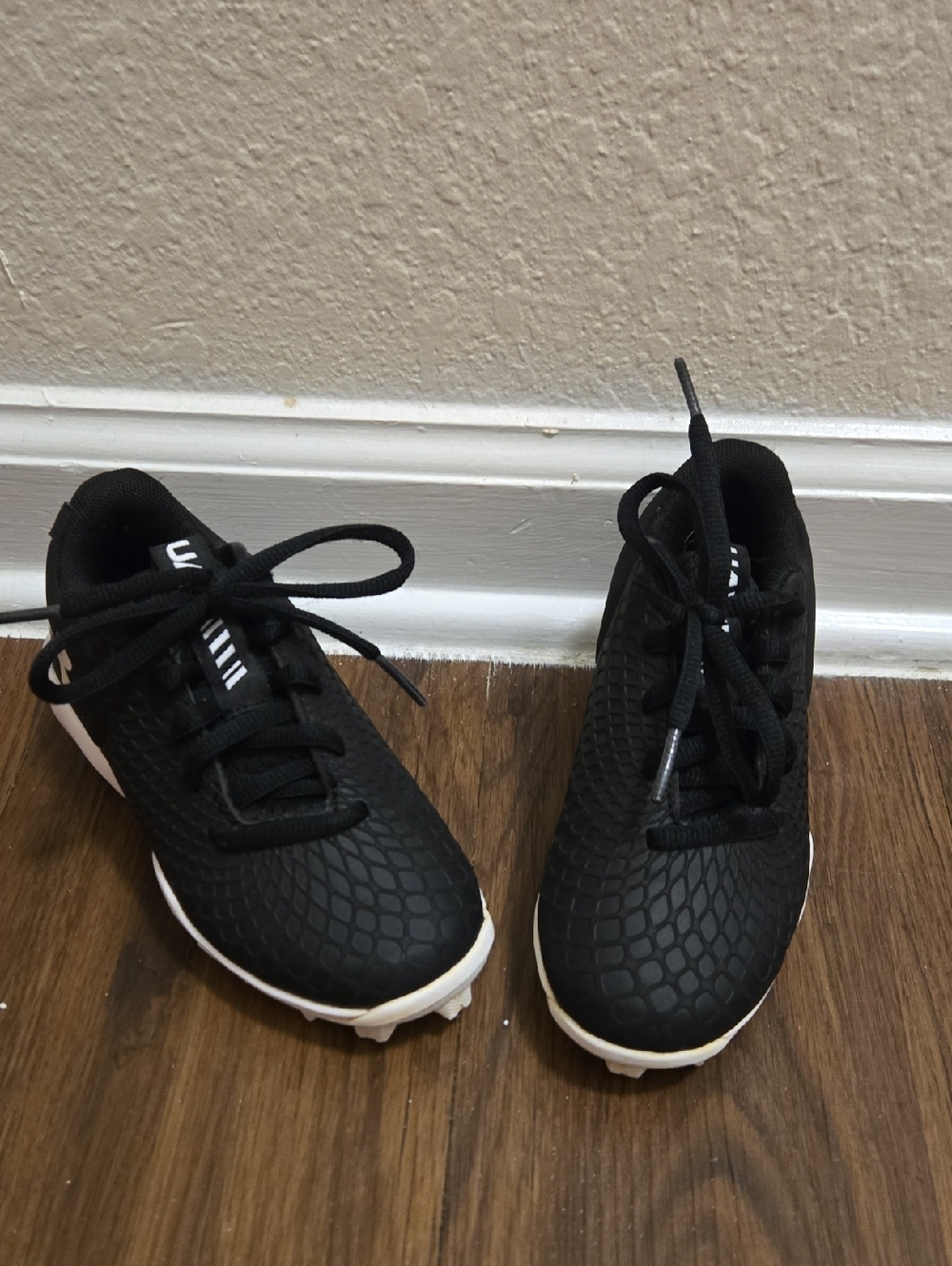 Kids Black Under Armour Cleated Athletic Shoes